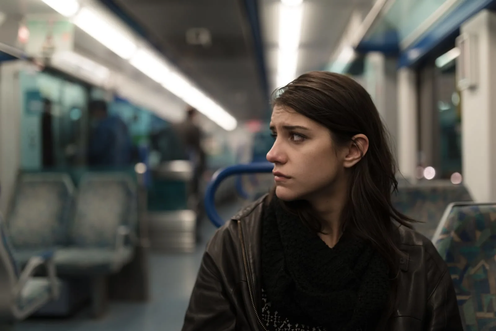 depressed young woman sitting in train