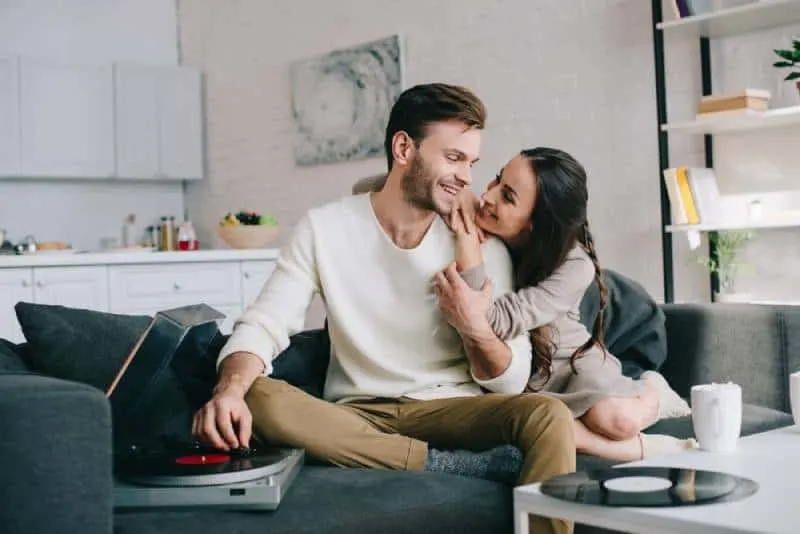 lovely couple listening music in living room