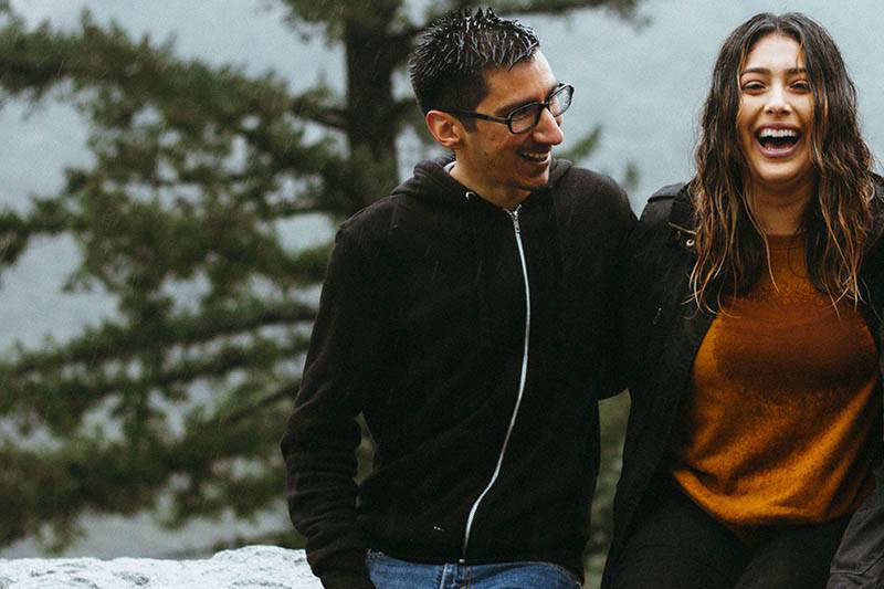 smiling couple standing outside