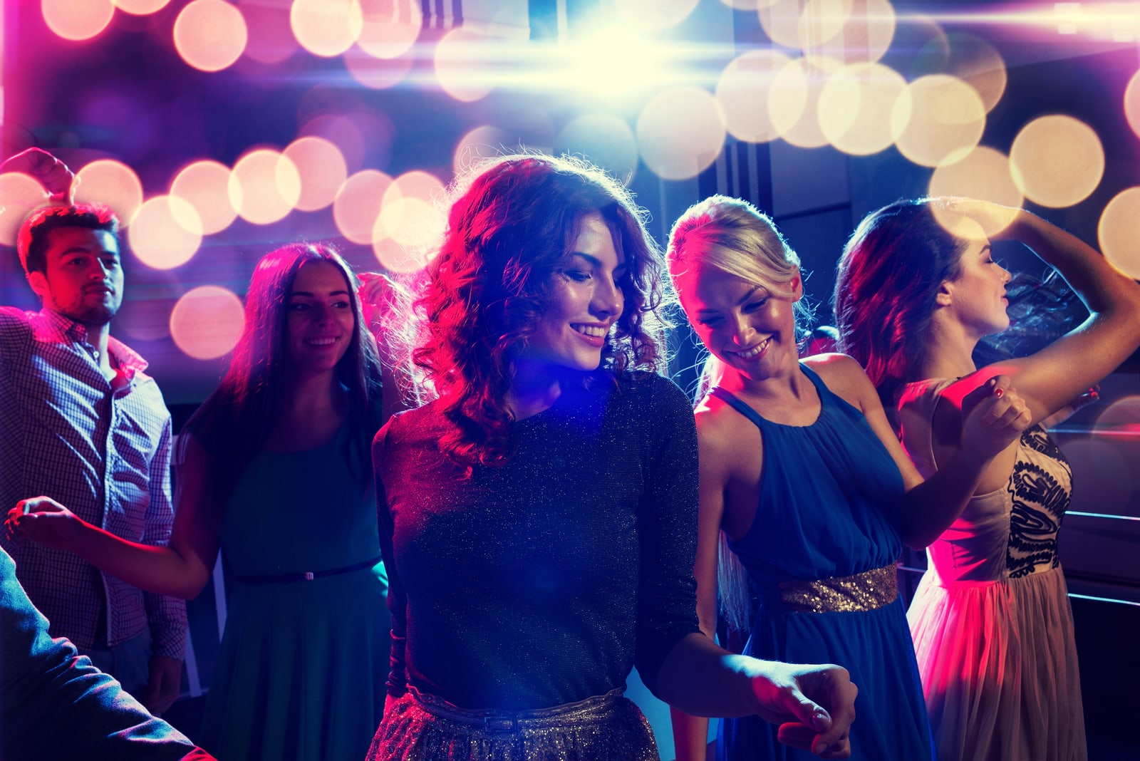 smiling women dancing in club