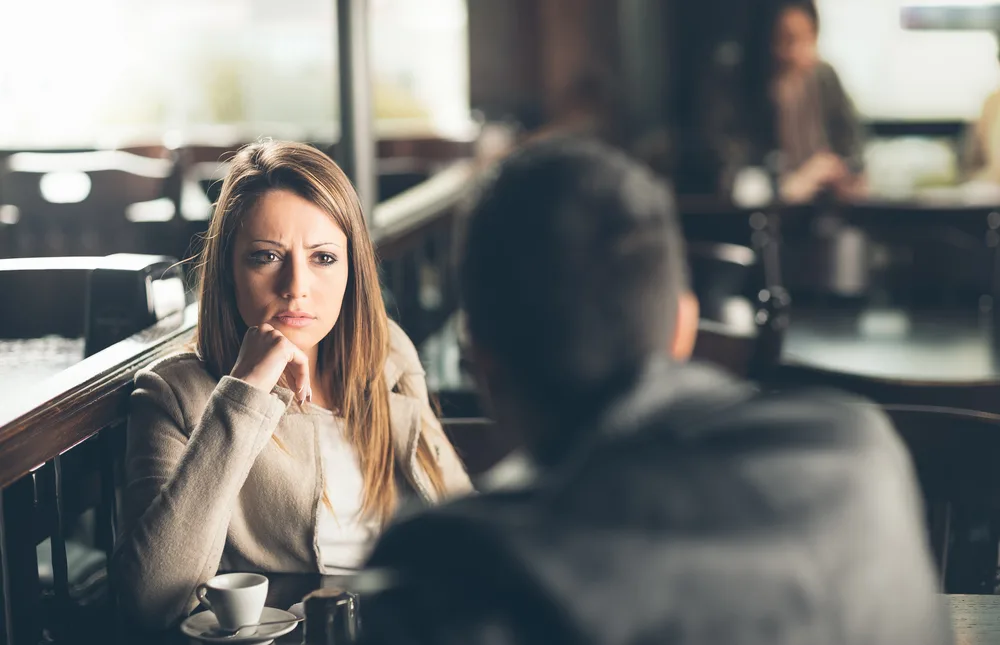 the woman looks at the man in disappointment