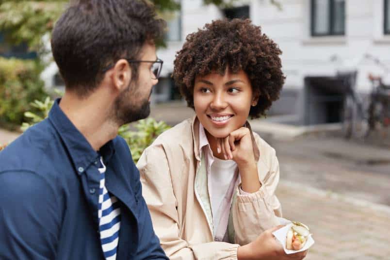 woman looking at man while he talking