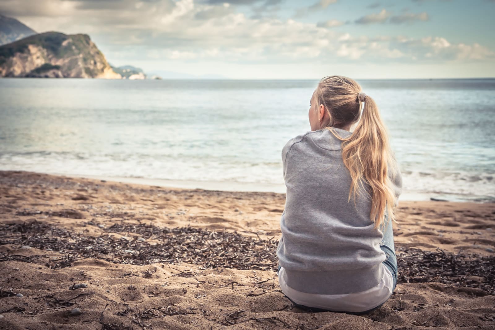 woman sitting on the beach alone