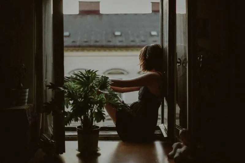 woman standing on door looking outside