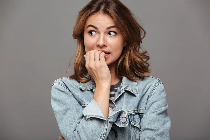 worried woman biting her nails