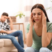 worried woman sitting apart from man