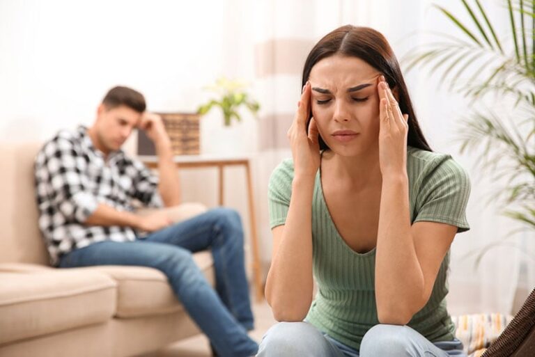 worried woman sitting apart from man