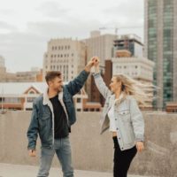smiling couple dancing on rooftop