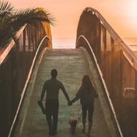 couple holding hands and walking outside