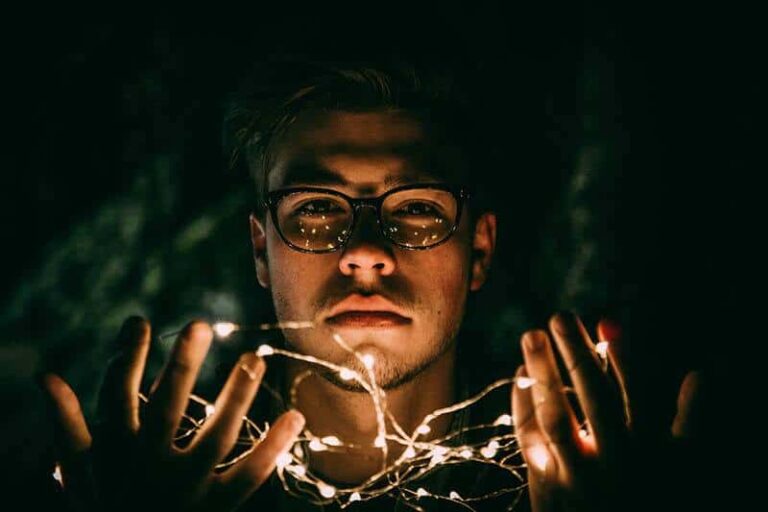 close up photo of man wearing eyeglasses at night