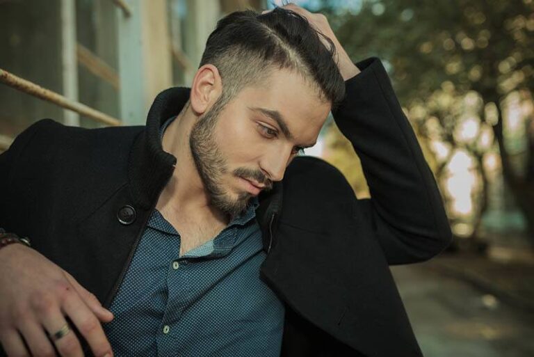 man touches his hair