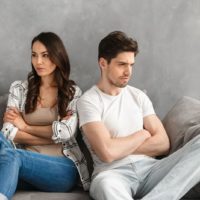 couple in fight sitting on the couch