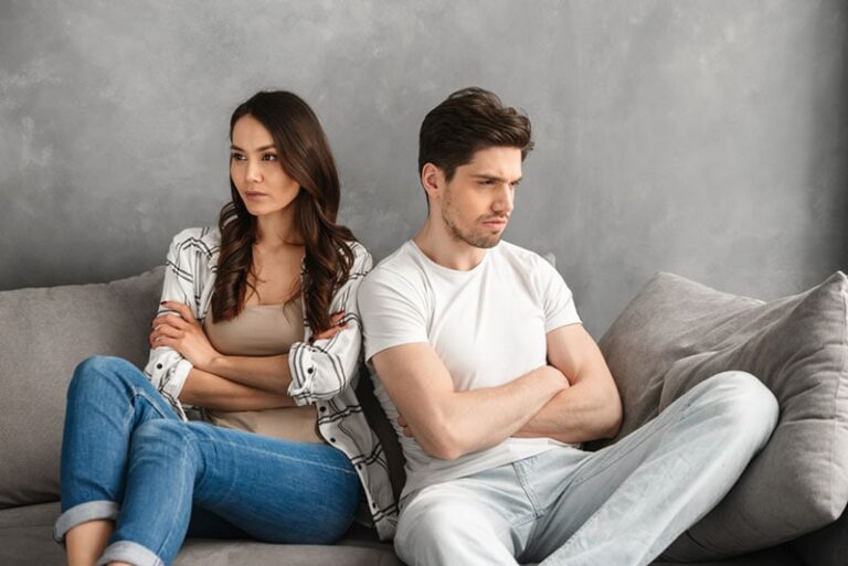 couple in fight sitting on the couch
