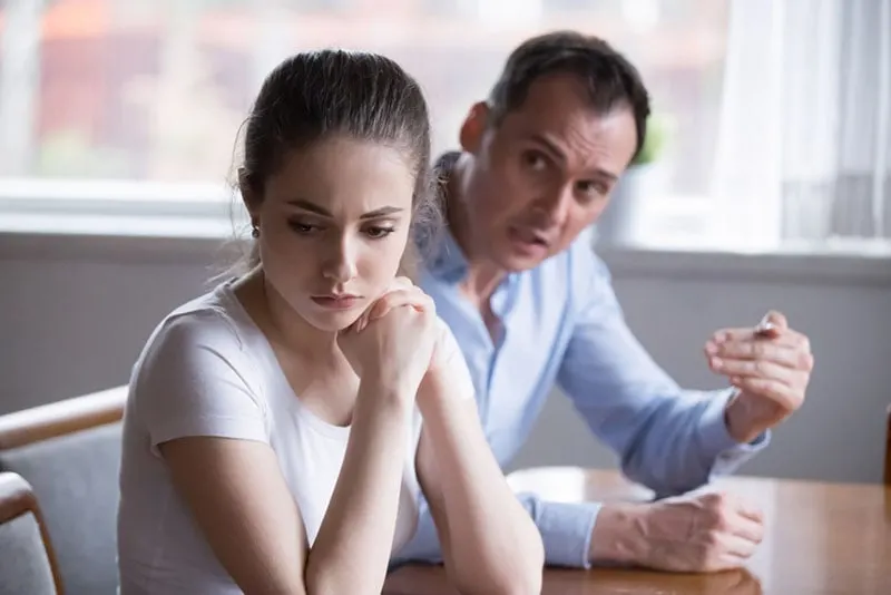 sad woman listening angry man