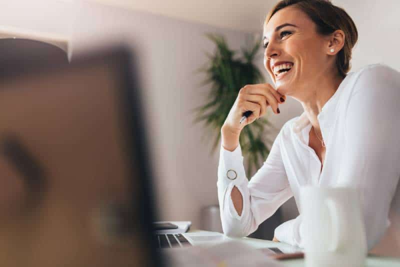 smiling business woman sitting at her desk