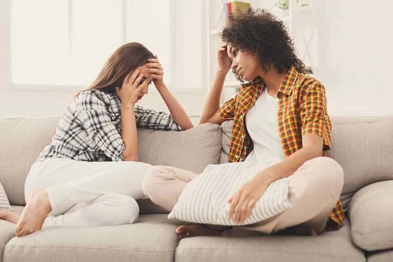 worried female friends talking
