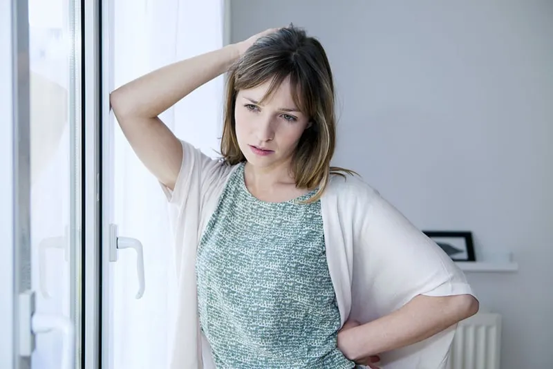 worried woman standing at home
