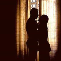 silhouette of man and woman standing close to each other