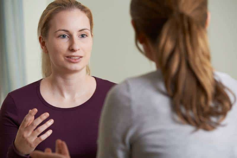 A young woman discusses her problems with a counselor
