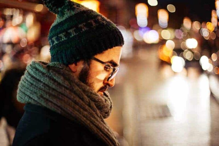 side view of man looking down on street