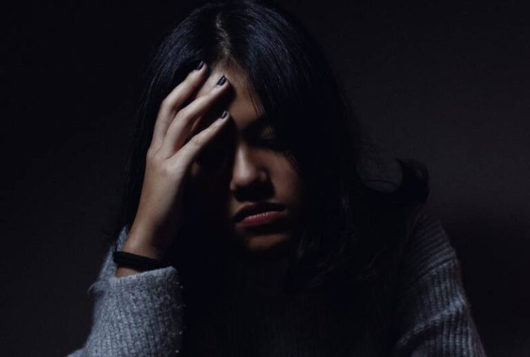 sad woman put hand on her forehead