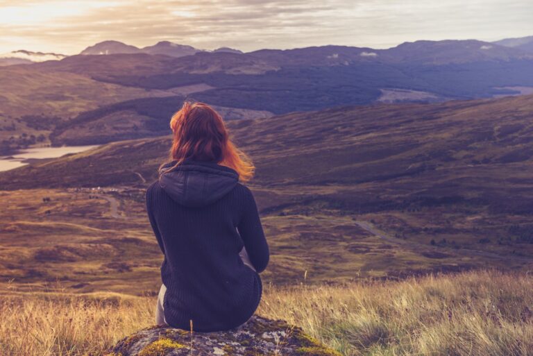 lonely woman sitting on the rock
