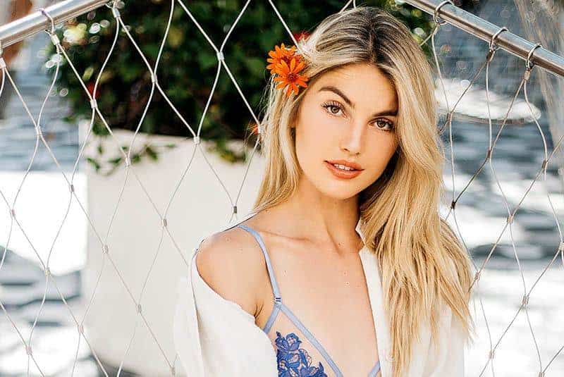 beautiful blonde woman having flower on her head