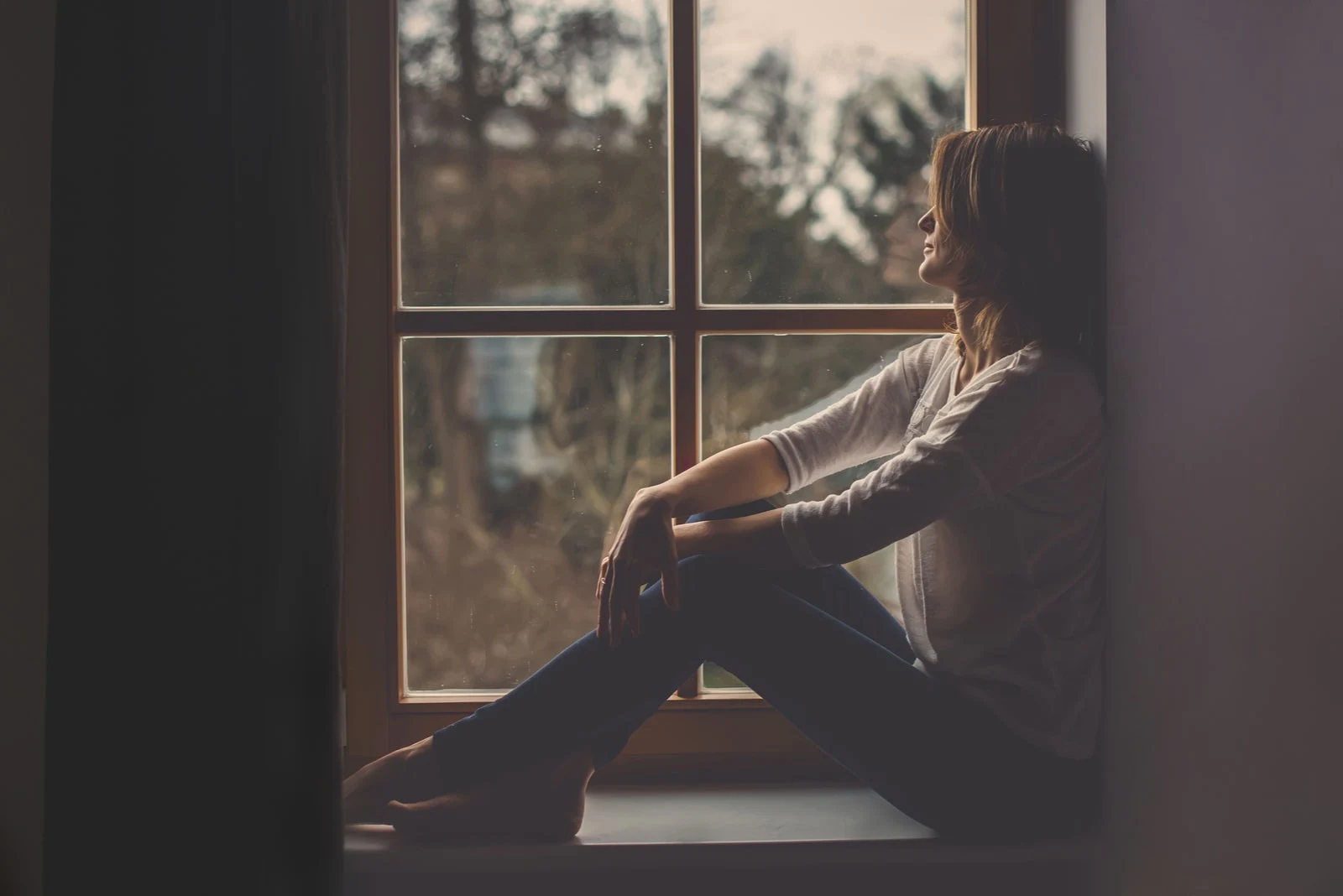 a woman sitting by the window