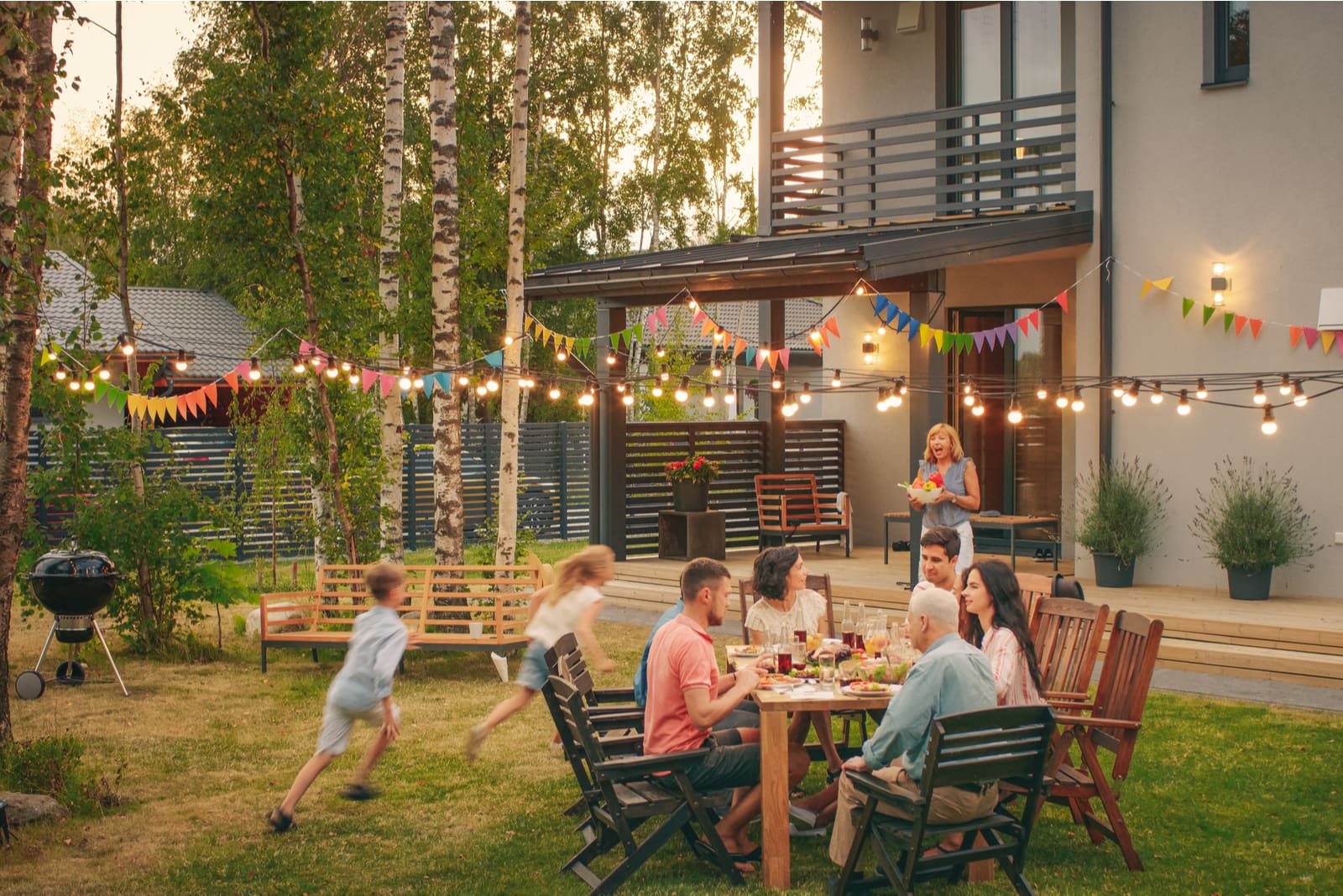 big happy family in the garden at the dinner table