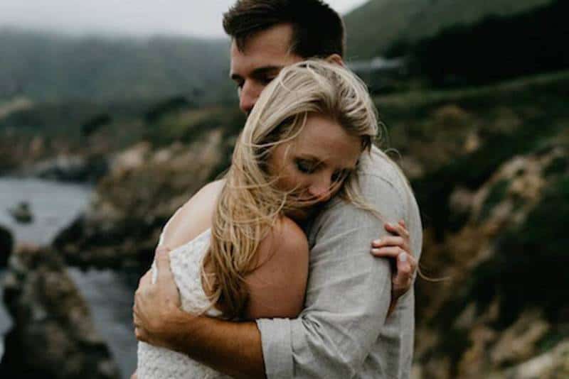 couple hugging on rocks