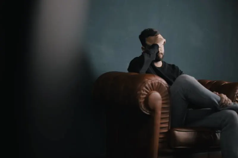 worried man sitting on sofa