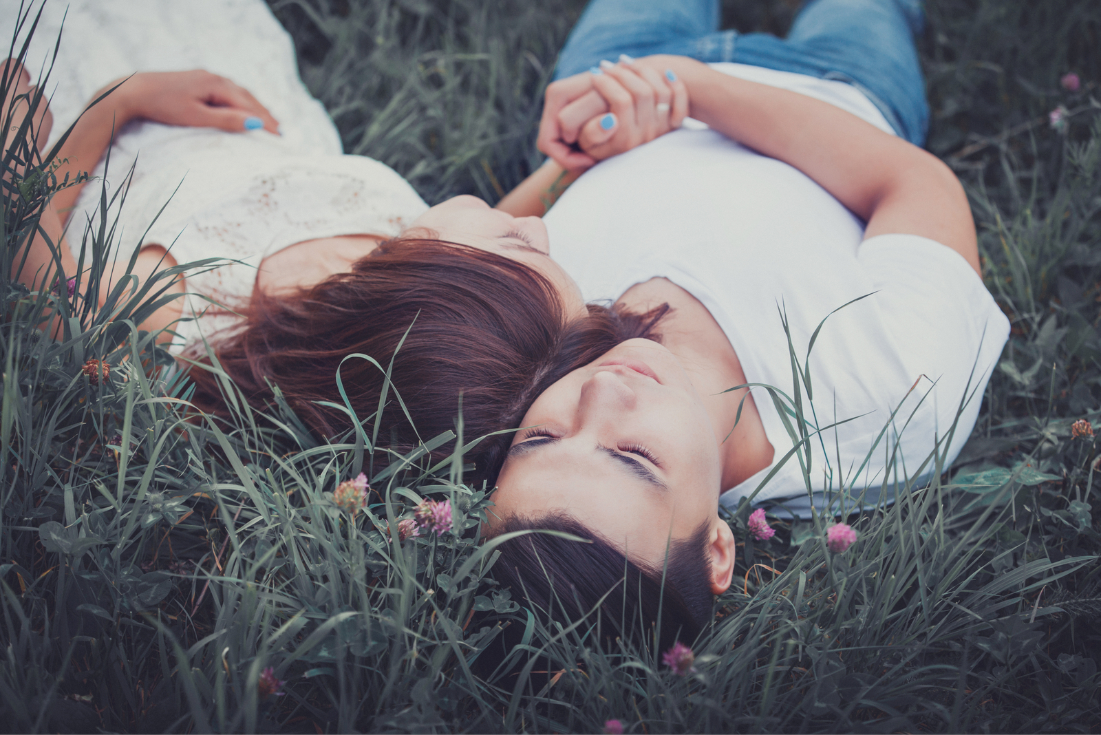 young couple lying on the grass