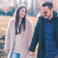 a loving couple walks holding hands