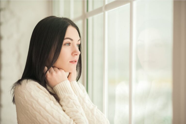 a woman sitting by the window