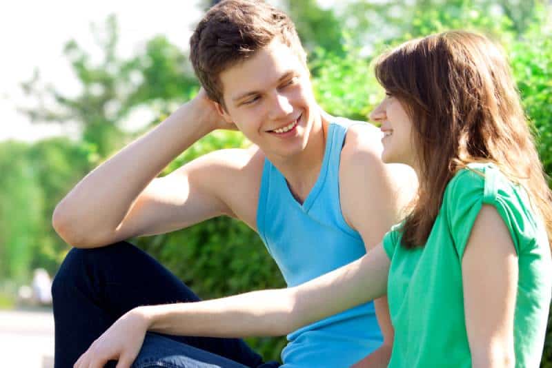 smiling couple talking outside