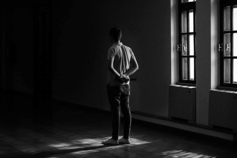 man holding hands behind back