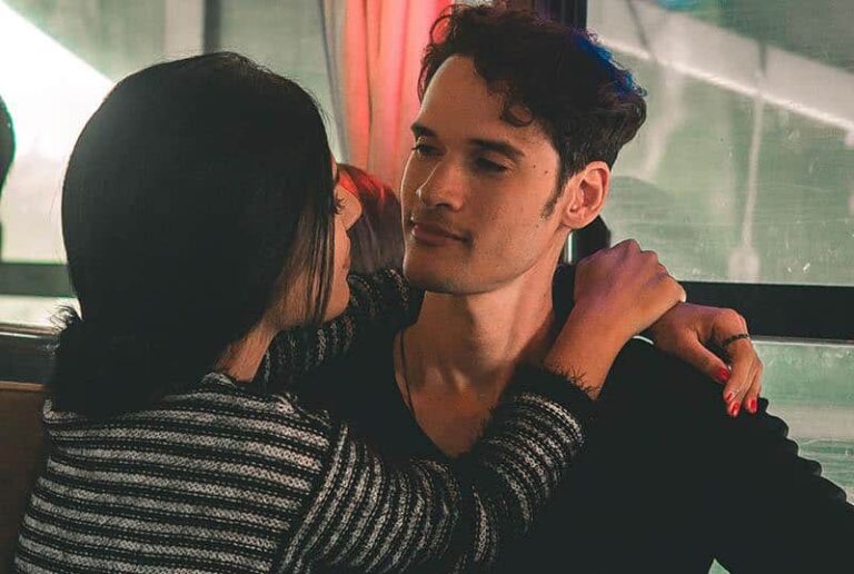 woman hugging man while looking each other