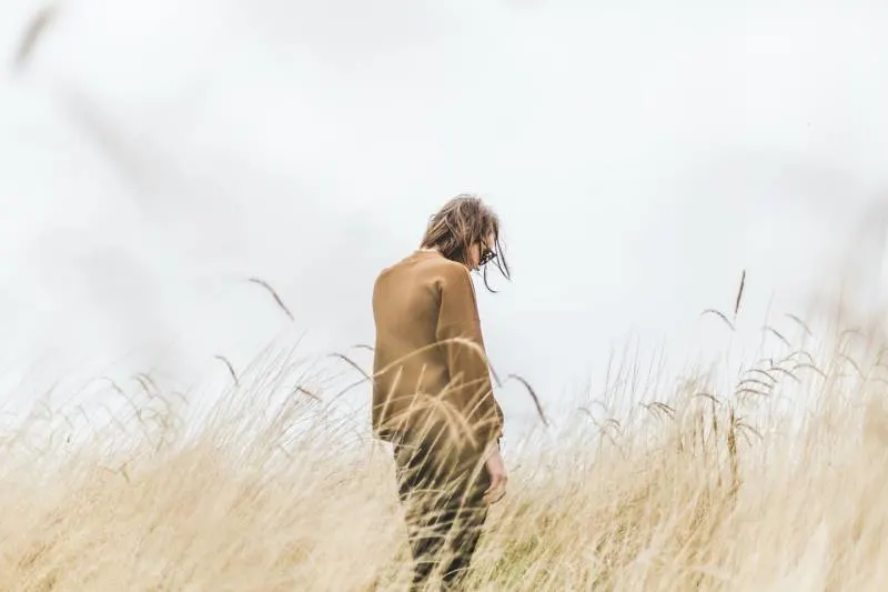 Person standing in the middle of the wheat field