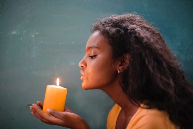 woman blowing to candle