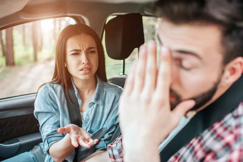 annoyed man listening woman in the car