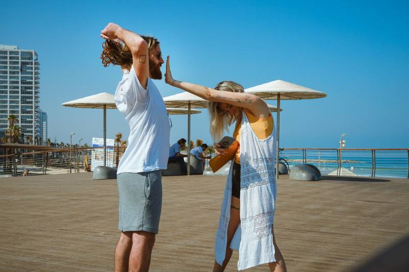 woman standing in front of a man during the day