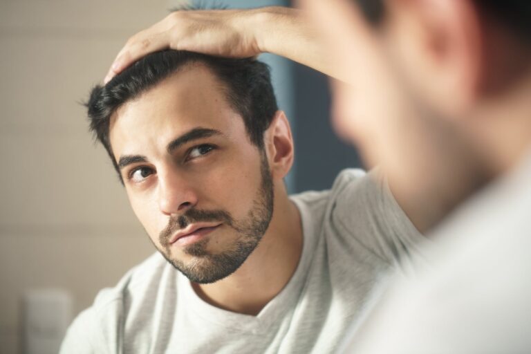 the man looks at himself in the mirror