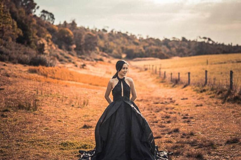 woman with black dress walking in nature