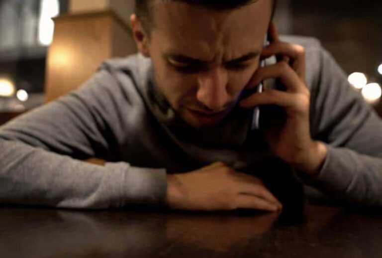 upset man talking on his phone