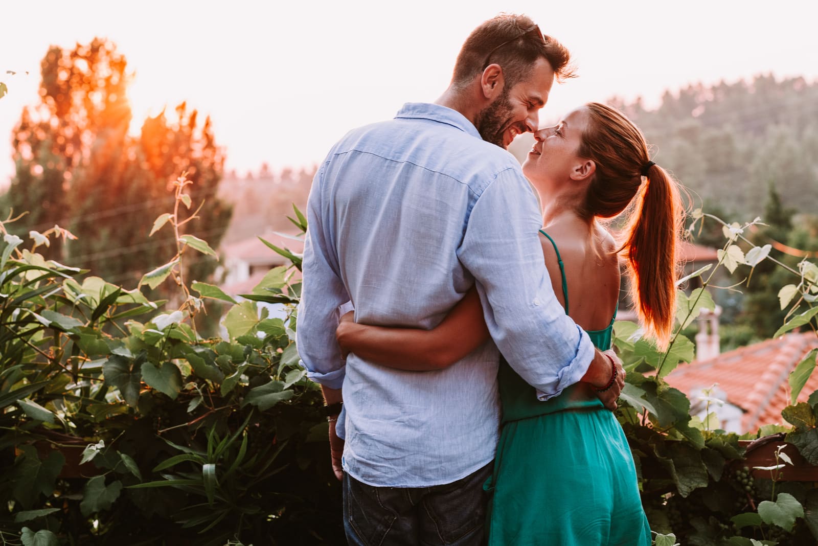 a man and a woman stand embracing