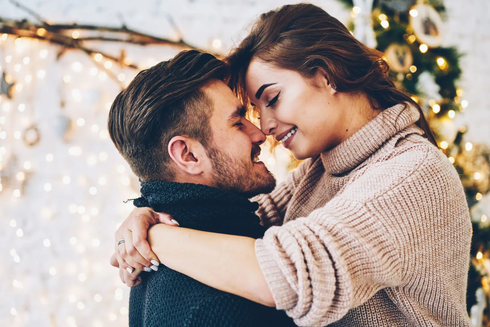 couple wearing sweaters hugging each other