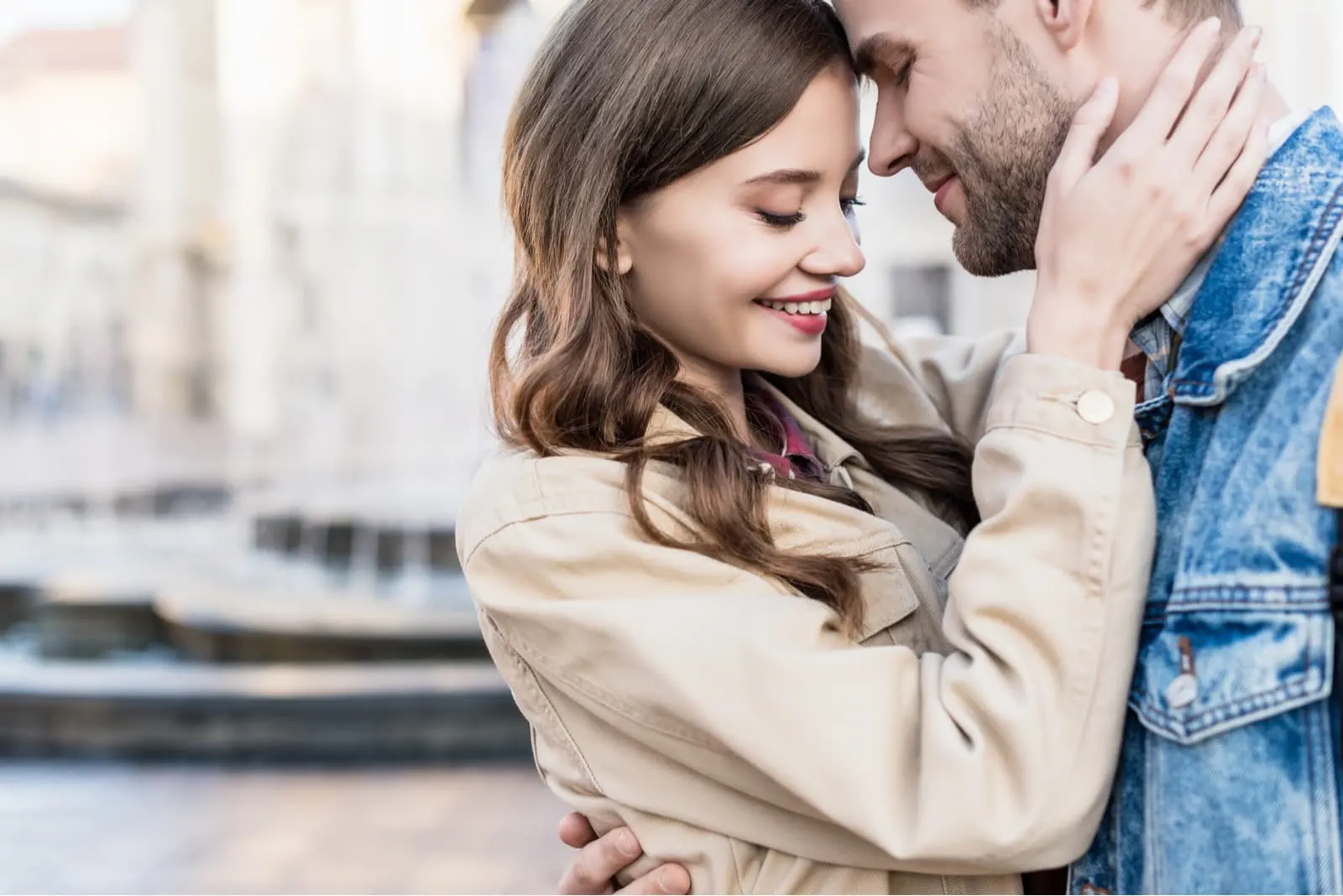 woman and man hugging, smiling and touching each other