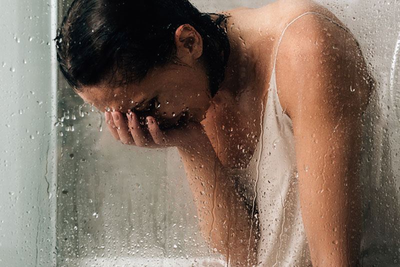 woman crying in the shower