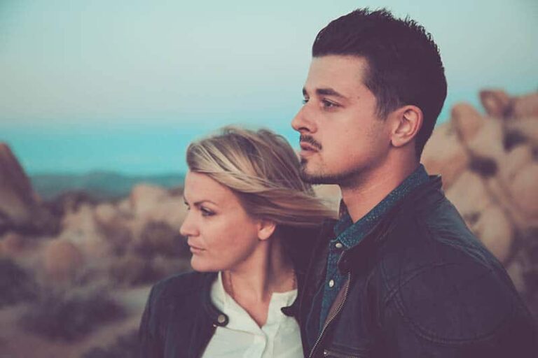 serious couple standing outside
