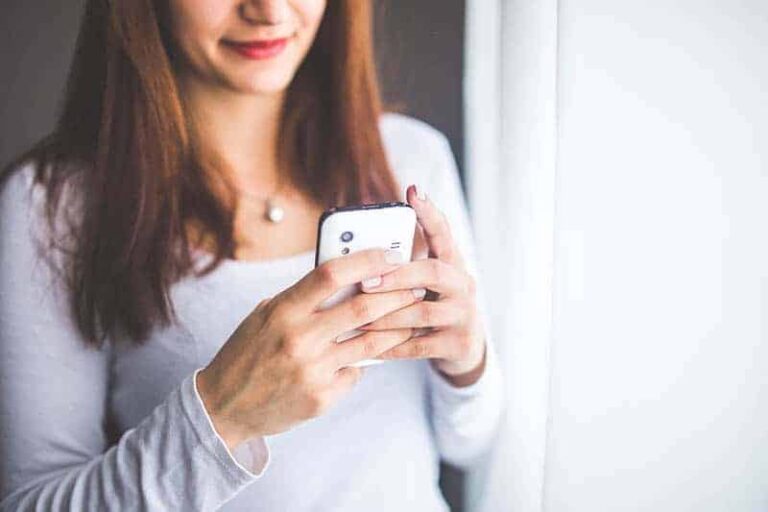 woman typing on her phone